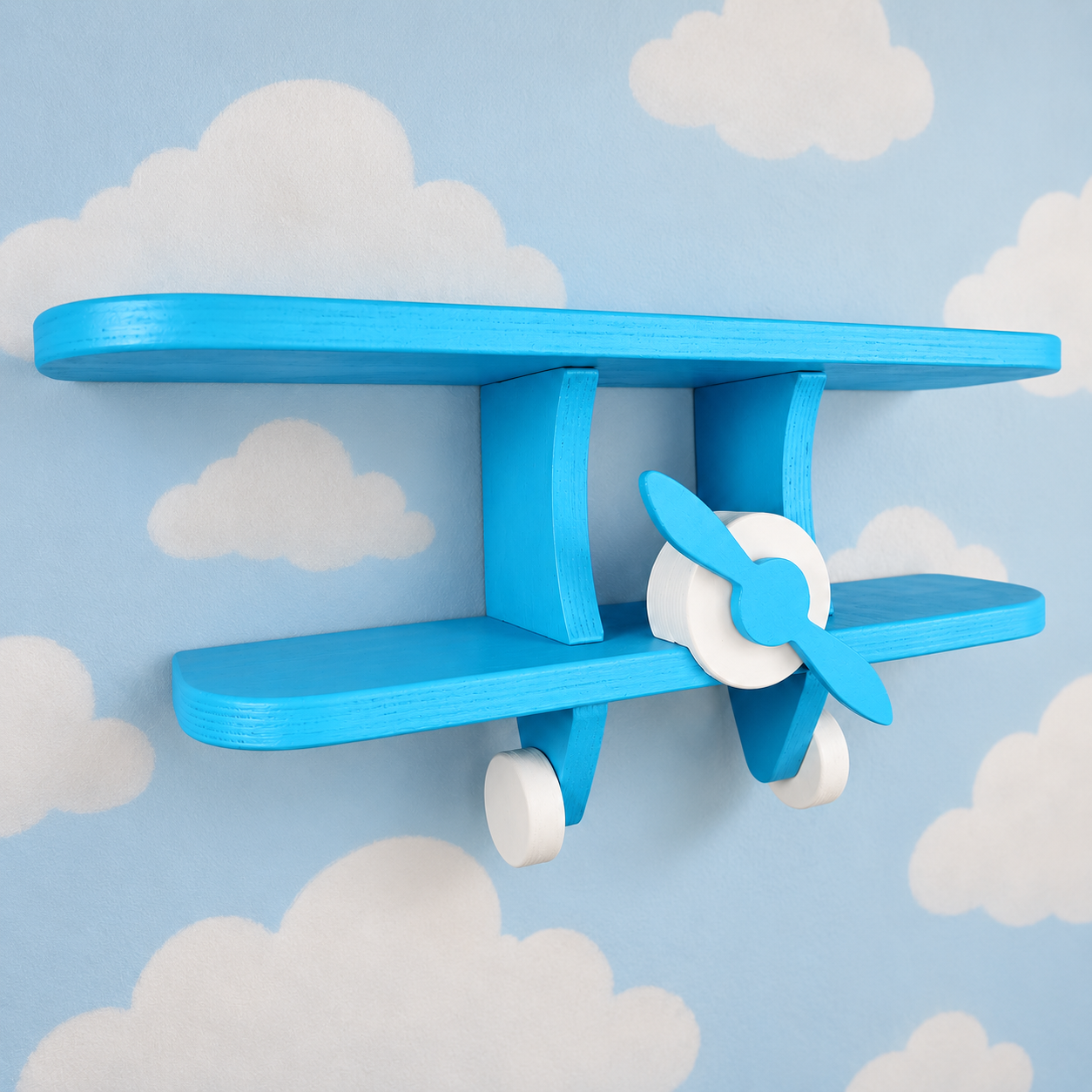 Blue wooden aeroplane wall shelf for kids shown at an angle